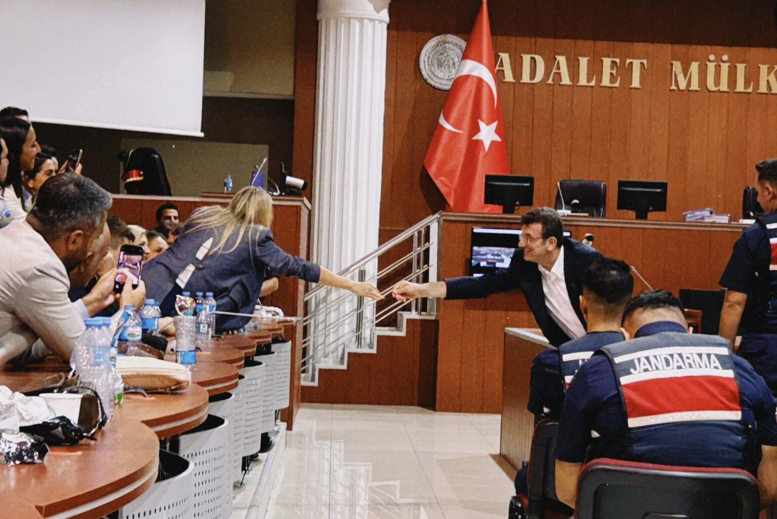 Der Oppositionsführer der Türkei, Imamoglu, der aus dem Stand des Angeklagten greift, um die Hand seiner Frau im Gerichtssaal zu halten