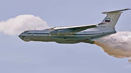 The Il-76 plane dumps water onto a tank range so that there